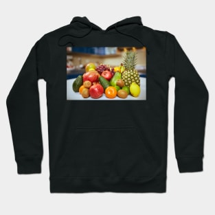 Exotic fruits on the table in the kitchen Hoodie